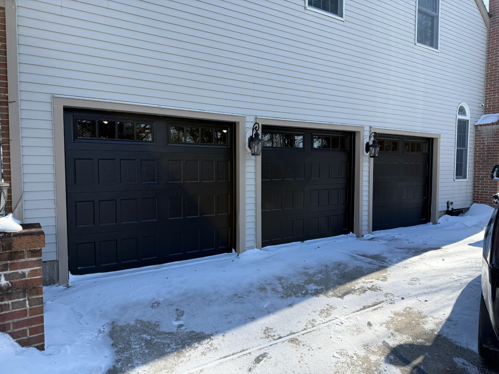 Three black garage doors installed by LIC
